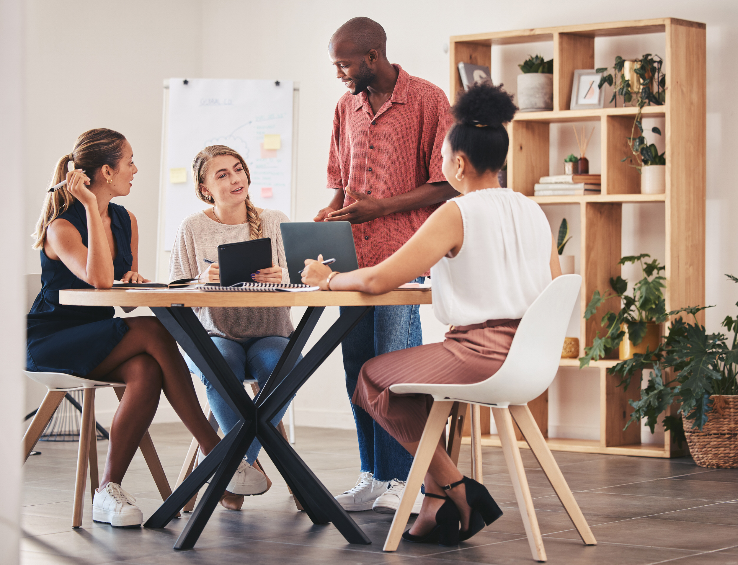 Burn Out Prävention – ein Team arbeitet an einem Tisch und bespricht sich